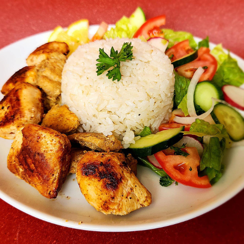 Chicken Kebab Plate - Grilled chicken kebab with rice, fresh vegetables, and lemon