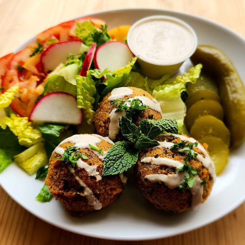 Falafel Plate - Golden fried falafel with tahini sauce, salad, and pickles
